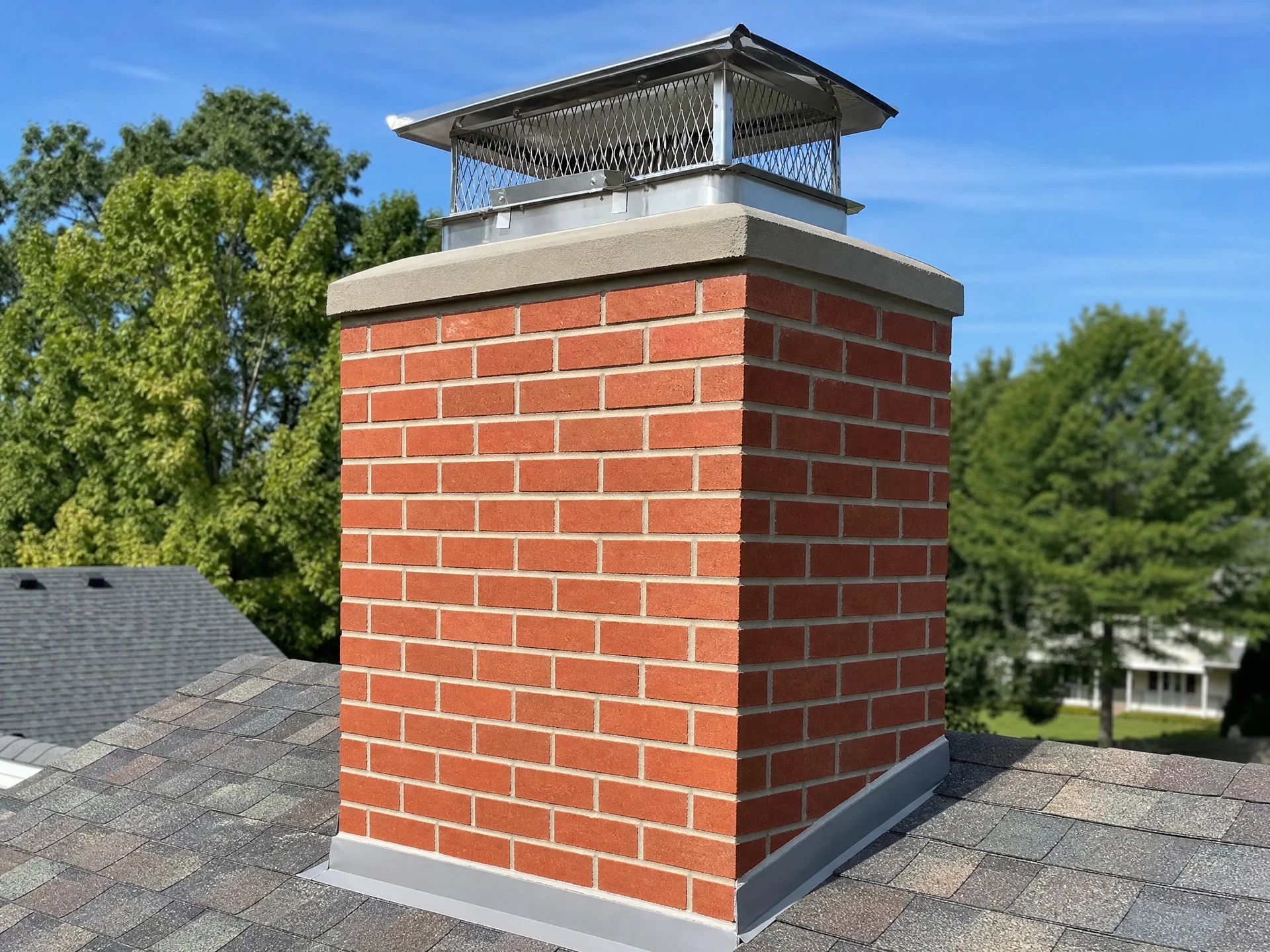 Rebuilt chimney crown with new stainless cap after restoration